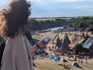 Person using a Buddycompass festival tracker at a music festival.