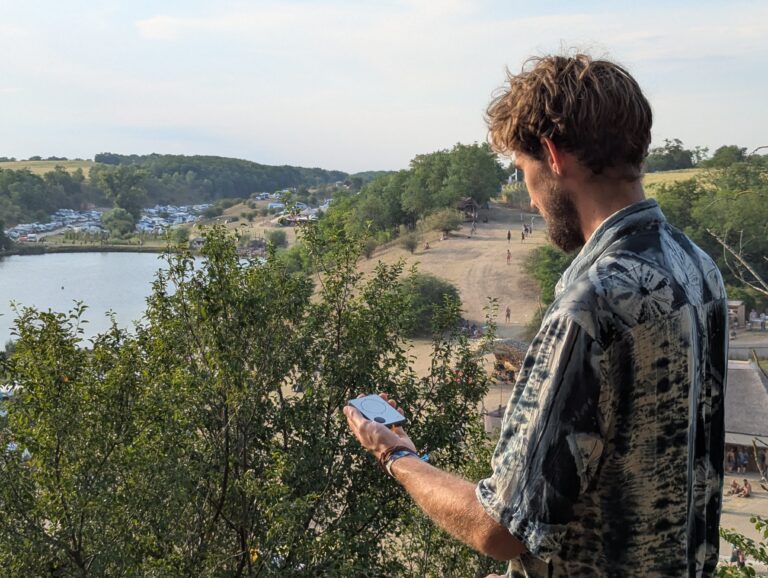 Person using a Buddycompass festival tracker at a music festival.