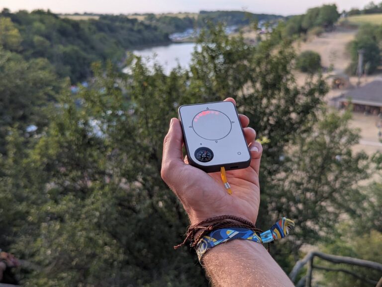 Person using a Buddycompass festival tracker at a music festival.