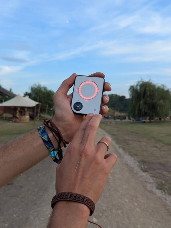 Person using a Buddycompass festival tracker at a music festival.