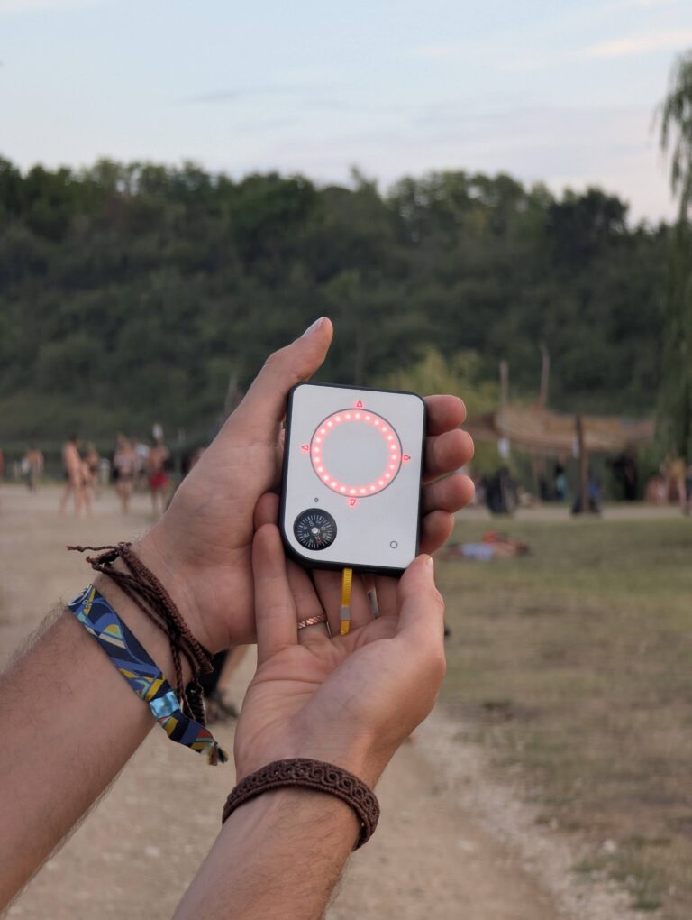 Person using a Buddycompass festival tracker at a music festival.