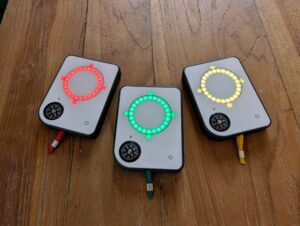 Three Buddycompass festival trackers with lights